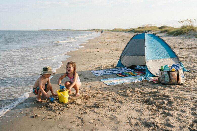Minimalist family beach setup with shade tent and children playing in sand near Texas coastline
