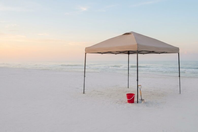 Simple beach setup with canopy and minimal gear on sandy Gulf Coast shore