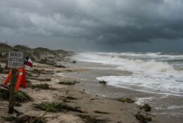 Storm clouds over Texas barrier island beach with rough surf and wet sand after tropical weather system passage
