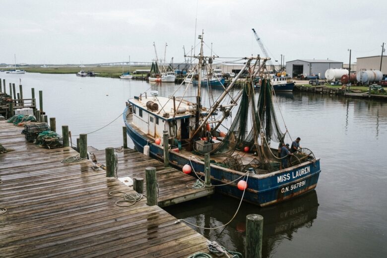 Commercial fishing vessel moored at Texas coastal dock with nets